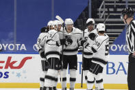 Los Angeles Kings' Adrian Kempe (9) is congratulated by teammates after scoring a goal against the St. Louis Blues during the second period of an NHL hockey game Saturday, Jan. 23, 2021, in St. Louis. (AP Photo/Joe Puetz)