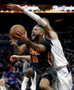 Orlando Magic guard Evan Fournier (10) is fouled by Dallas Mavericks forward Kristaps Porzingis while going up to shoot during the second half of an NBA basketball game, Friday, Feb. 21, 2020, in Orlando, Fla. (AP Photo/John Raoux)