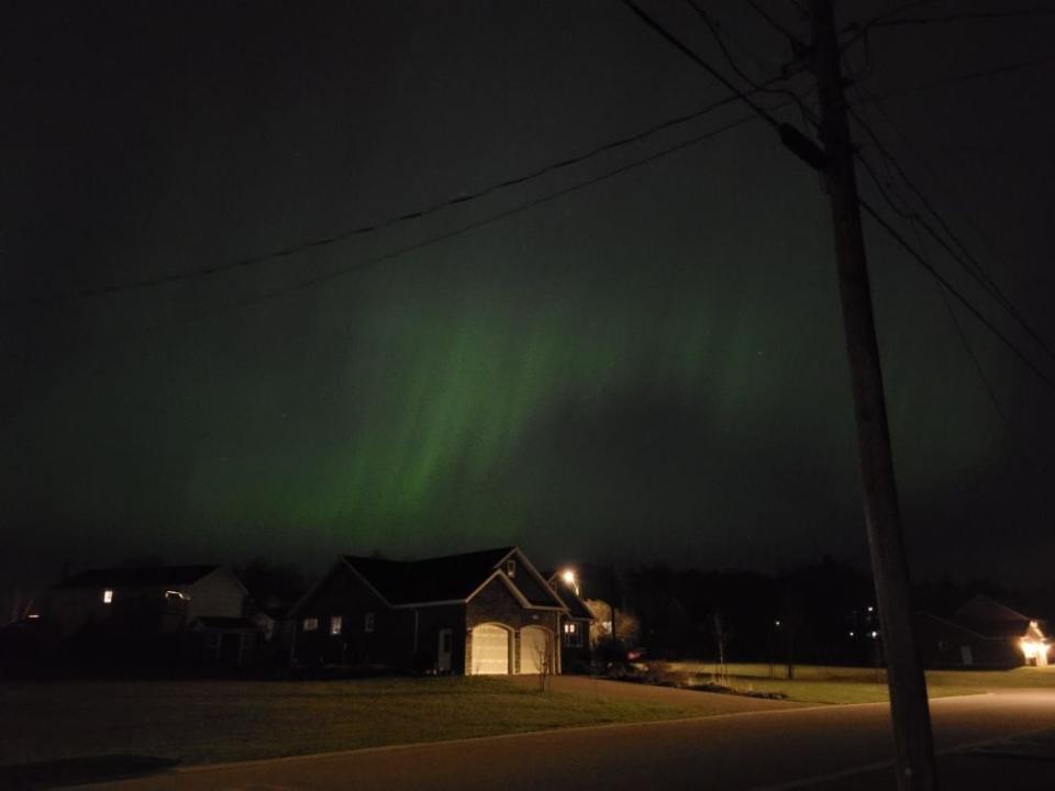Northern lights over a house.