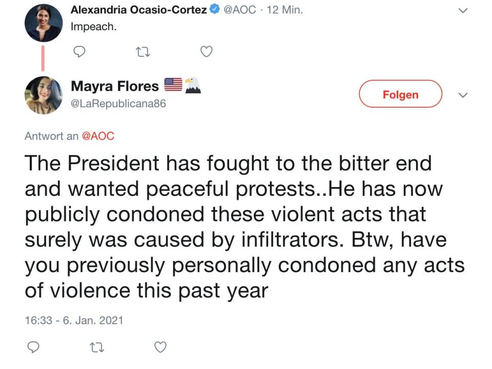 Flores replies to a tweet from AOC, suggesting January 6 was "caused by infiltrators."