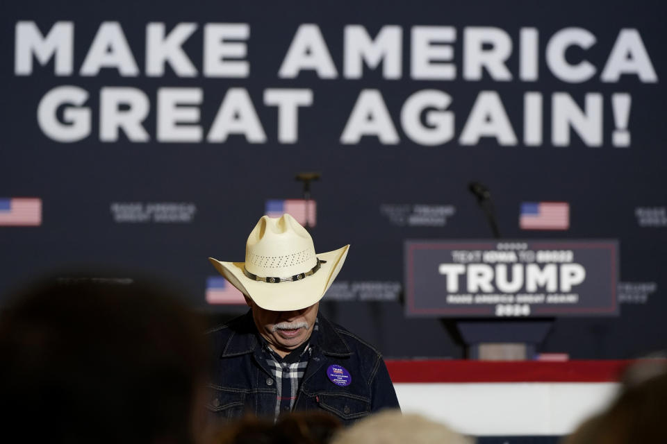 An audience member waits for former President Donald Trump to arrive at a commit to caucus rally, Wednesday, Dec. 13, 2023, in Coralville, Iowa. (AP Photo/Charlie Neibergall)