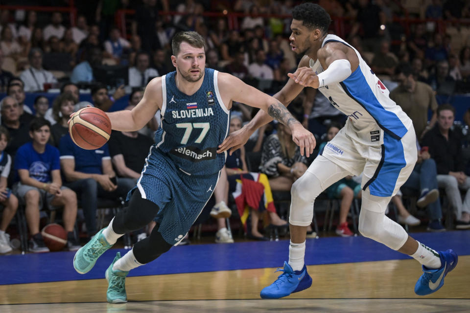 CORRECTION / Slovenia's Luka Doncic (L) is marked by Greece's Giannis Antentokoumpo during the 2024 FIBA Olympic Qualifying Tournament semi-final basketball match between Greece and Slovenia at the Peace and Friendship Stadium in Athens, on July 6, 2024. (Photo by Aris MESSINIS / AFP) / 