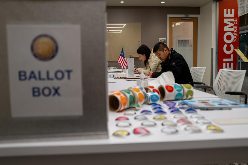 People participate in voting in the upcoming midterm elections at a Native Alaskan voting station 