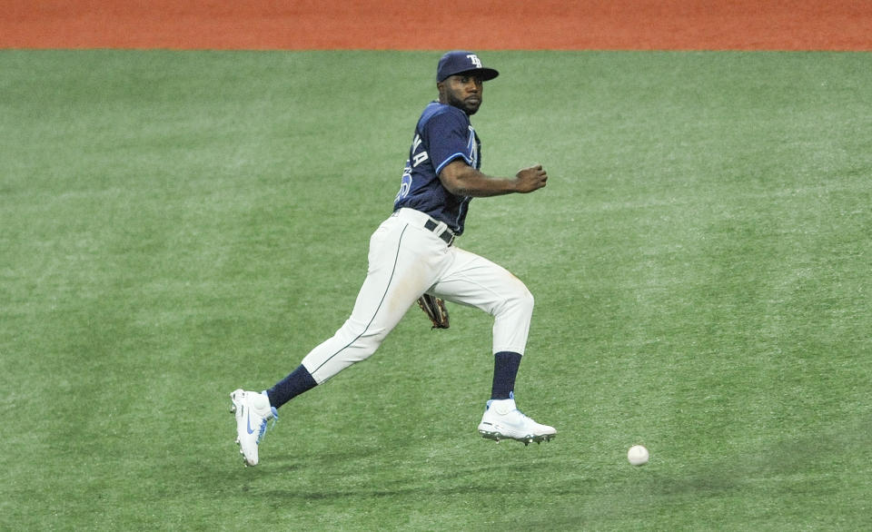 Tampa Bay Rays right fielder Randy Arozarena chases a RBI-double hit by Texas Rangers' Charlie Cuberson during the fourth inning of a baseball game Tuesday, April 13, 2021, in St. Petersburg, Fla. (AP Photo/Steve Nesius)