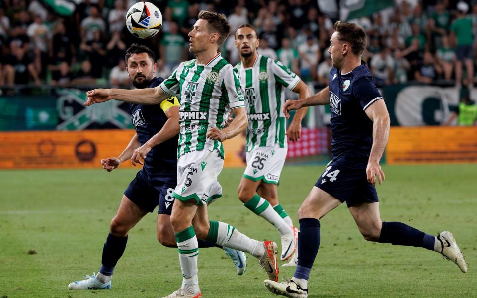 Kristoffer Zachariassen of Ferencvaros competes for the ball with Ryan Brobbell (left) and Daniel Williams (right) of The New Saints FC during the UEFA Champions League Second Qualifying Round first leg match at Groupama Arena on July 23, 2024 in Budapest, Hungary.