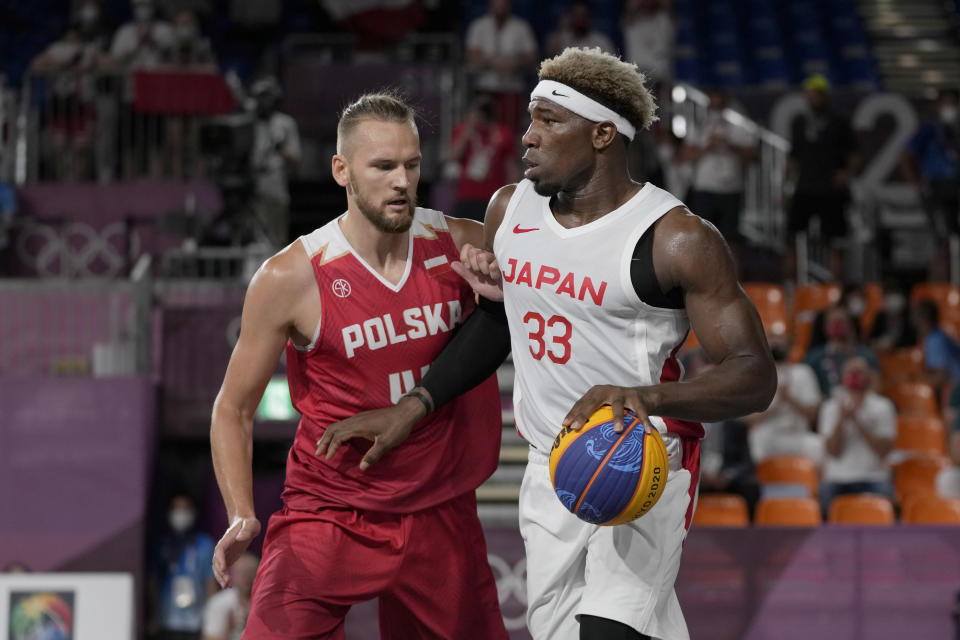 Japan's Ira Brown (33) dribbles as Poland's Szymon Rduch (44) defends during a men's 3-on-3 basketball game at the 2020 Summer Olympics, Saturday, July 24, 2021, in Tokyo, Japan. (AP Photo/Jeff Roberson)