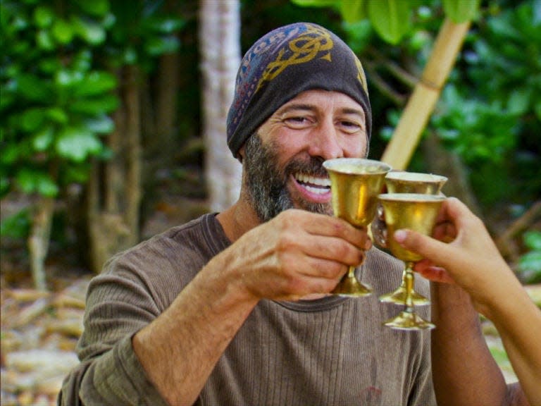 Tony Vlachos, a "Survivor" player, smiling and wearing a hat