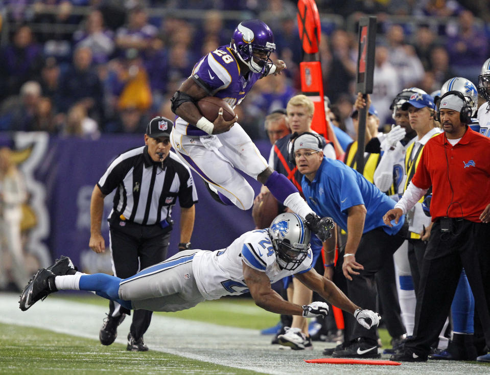 Minnesota Vikings running back Adrian Peterson (28) leaps over Detroit Lions safety Erik Coleman (24) during the second half of their NFL football game in Minneapolis, November 11, 2012. REUTERS/Eric Miller (UNITED STATES - Tags: SPORT FOOTBALL TPX IMAGES OF THE DAY)