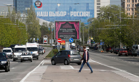A banner (top), which reads "Our choice is Russia!", is on display in a street in the separatist-controlled city of Donetsk, Ukraine April 25, 2019. REUTERS/Alexander Ermochenko