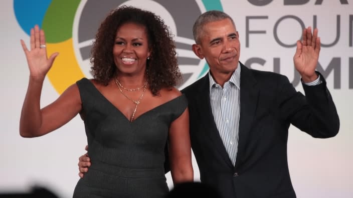 This October 2019 photo shows former U.S. President Barack Obama (left) and former First Lady Michelle Obama (right) closing the annual Obama Foundation Summit together on the campus of the Illinois Institute of Technology in Chicago, Illinois. (Photo by Scott Olson/Getty Images)
