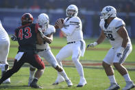 Utah State quarterback Logan Bonner (1) drops back to pass as Utah State linebacker Tyson Chisholm (43) rushes in the first half during an NCAA college football game for the Mountain West Conference Championship, Saturday, Dec. 4, 2021, in Carson, Calif. (AP Photo/John McCoy)