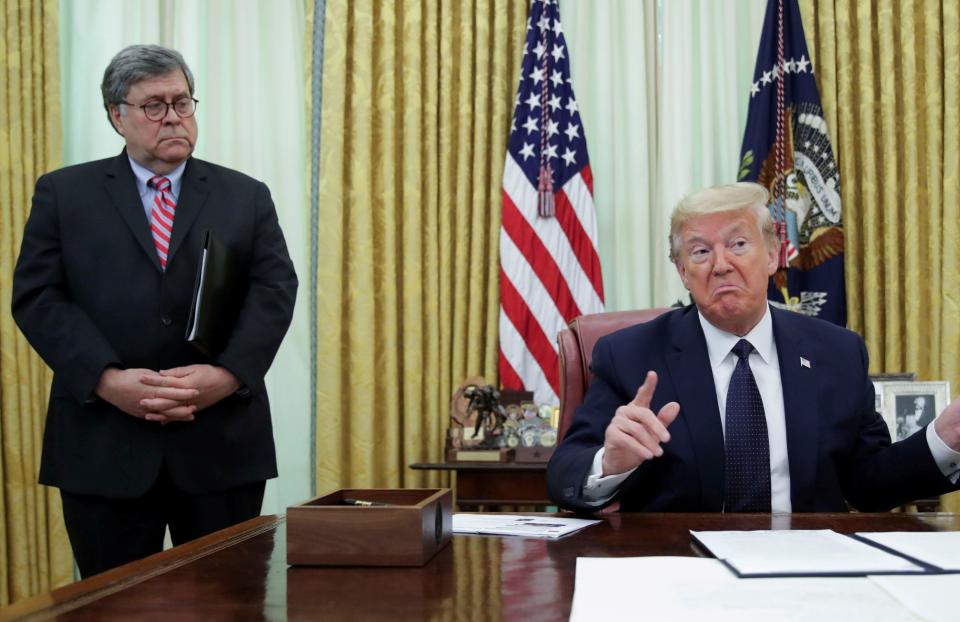 President Donald Trump speaks to reporters in the Oval Office in May as Attorney General William Barr listens. (Photo: Jonathan Ernst / Reuters)