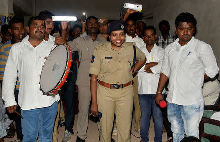 Rema Rajeshwari (C), a superintendent of police, speaks to villagers during a campaign to raise awareness on fake news in a village in Gadwal, India, July 23, 2018. REUTERS/Stringer