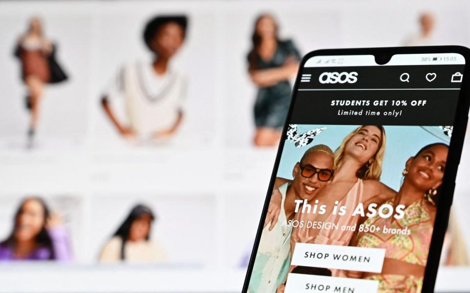 n illustration with a laptop and mobile phone shows the website of online fashion retailer ASOS - JUSTIN TALLIS /AFP 