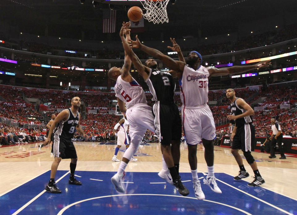 LOS ANGELES, CA - MAY 19: Kawhi Leonard #2 of the San Antonio Spurs shoots over Reggie Evans #30 and Caron Butler #5 of the Los Angeles Clippers in Game Three of the Western Conference Semifinals in the 2012 NBA Playoffs on May 19, 2011 at Staples Center in Los Angeles, California. (Photo by Stephen Dunn/Getty Images)