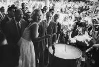 <p>Marilyn was the guest of honor at a ribbon-cutting ceremony for the Time-Life Building in New York City. She's lighting the giant firecracker with a giant match. </p>