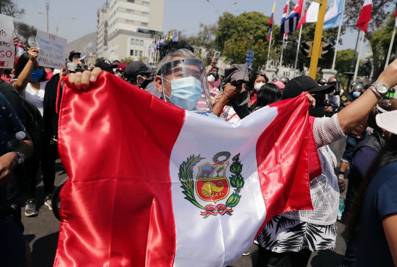 People react after Peru's interim President Manuel Merino announced his resignation, in Lima