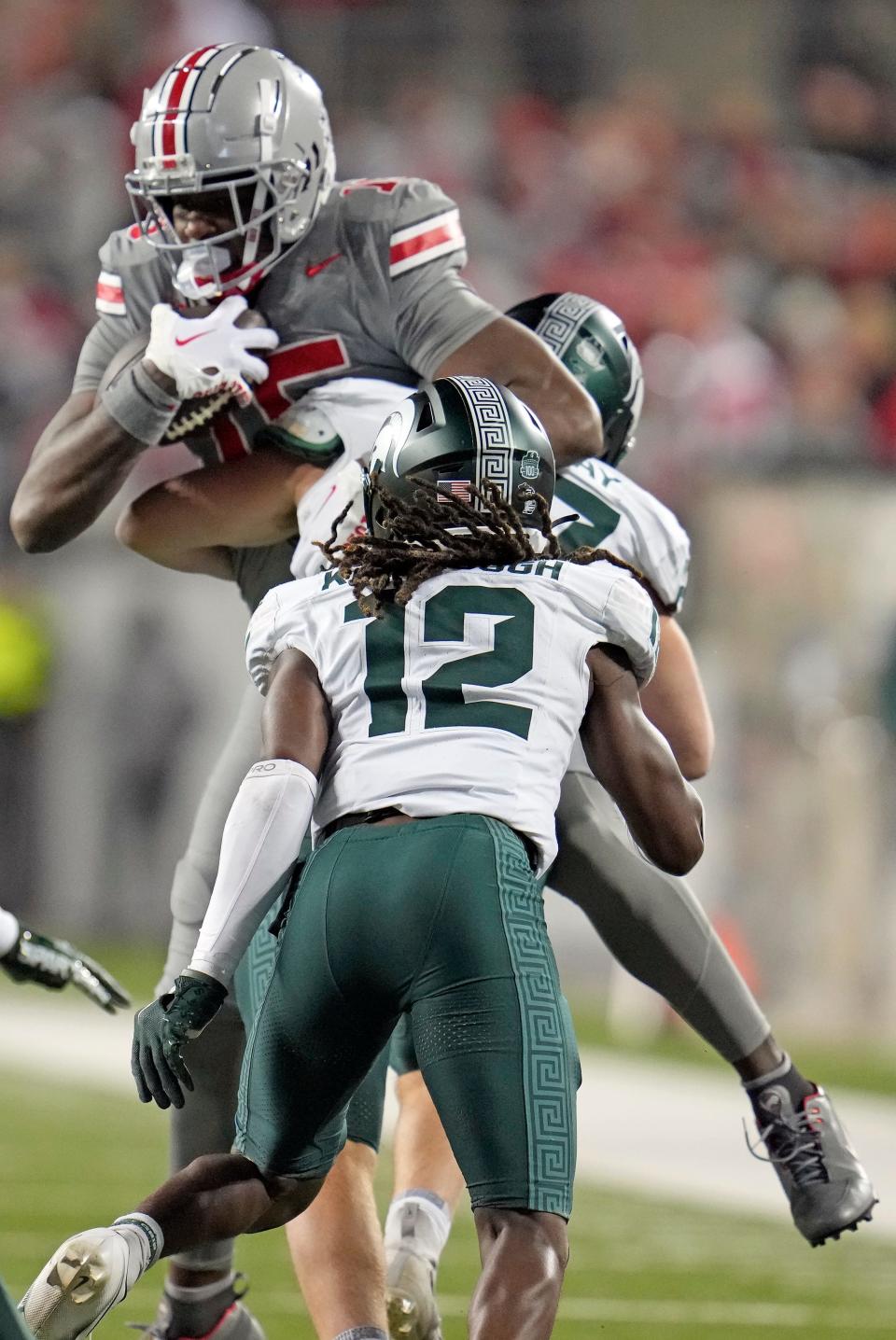 Nov 11, 2023; Columbus, Ohio, USA; Ohio State Buckeyes tight end Jelani Thurman (15) is tackled by Michigan State Spartans linebacker Cal Haladay (27) in the second half of the NCAA football game against Michigan State University at Ohio Stadium. The Buckeyes defeated the Spartans 38 to 3.