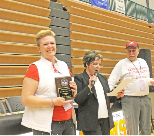 Coldwater's Kim Nichols, shown here after winning the MHSGCJA Coach of the Year award, recently announced her retirement from coaching the Cardinal Gymnastics program, along with her assistant Janet Kahler.