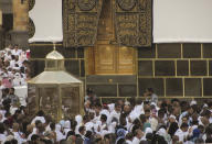 Muslim pilgrims circumambulate around the Kaaba, the cubic building at the Grand Mosque, as others watch Maqam Ibrahim, or the Station of Abraham, at left, in the Saudi Arabia's holy city of Mecca, Tuesday, July 5, 2022. Saudi Arabia is expected to receive one million Muslims to attend Hajj pilgrimage, which will begin on July 7, after two years of limiting the numbers because coronavirus pandemic. (AP Photo/Amr Nabil)