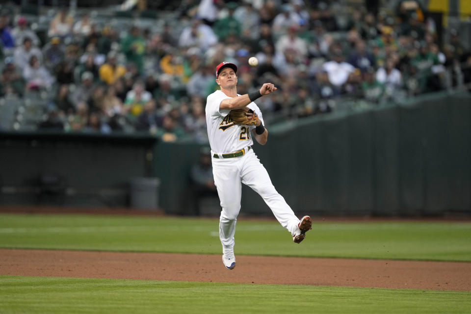 Oakland Athletics third baseman Matt Chapman (throws to first base for the out on a grounder by Boston Red Sox's Christian Vazquez during the fourth inning of a baseball game Friday, July 2, 2021, in Oakland, Calif. (AP Photo/Tony Avelar)