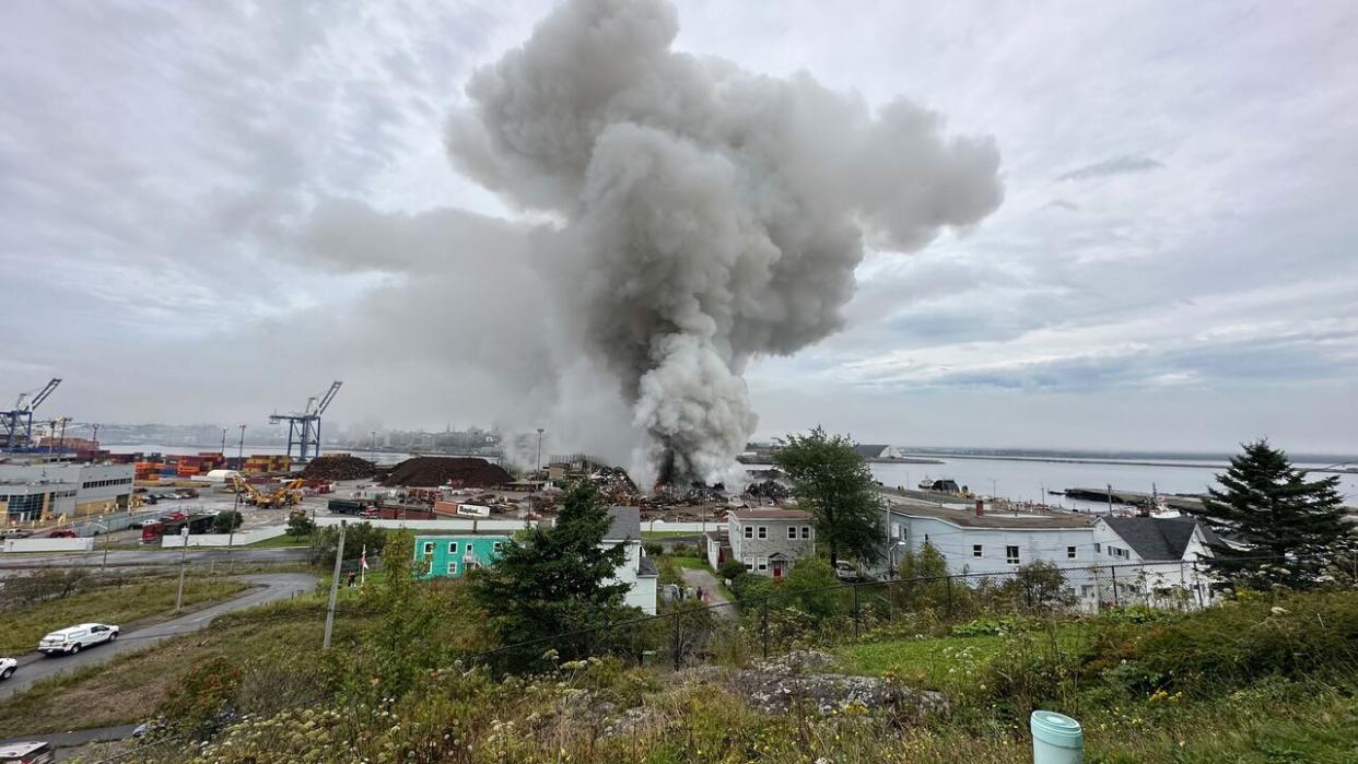 The metal scrapyard on Saint John's waterfront, which was the site of a major two-day fire last September, has had its assessed value for taxes lowered for 2024. That means its municipal property tax bill will fall, even as houses in neighbourhoods around it pay more. (Roger Cosman/CBC - image credit)