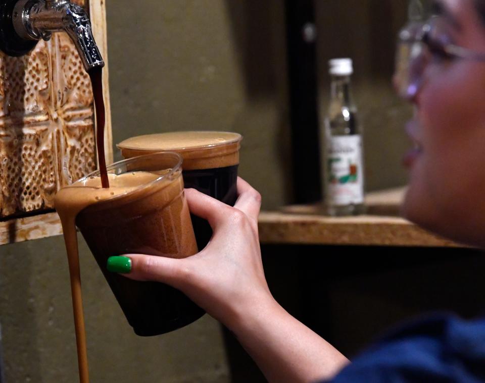 Bartender Devenie Medina fills beer orders as fast as she can on the last day.