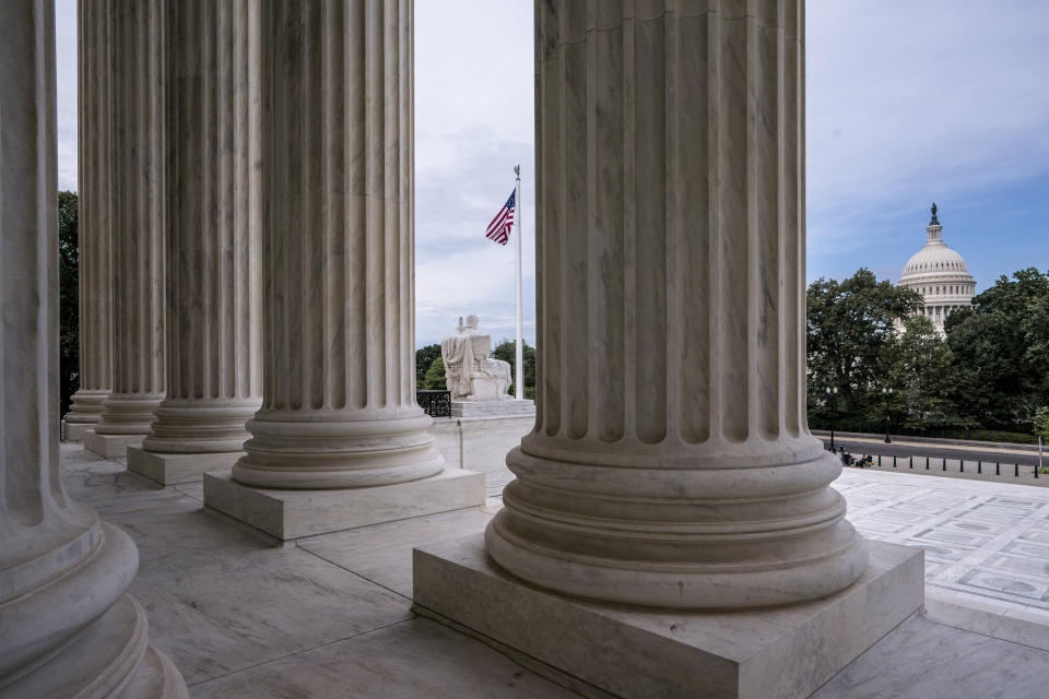 The columns of the Supreme Court are seen with the Capitol at right, in Washington, early Monday, June 15, 2020. (AP Photo/J. Scott Applewhite)