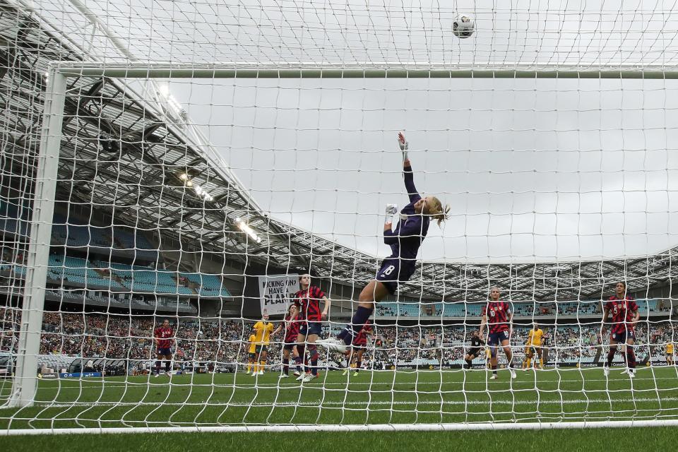 Casey Murphy leaves her feet to make a save for the USWNT.