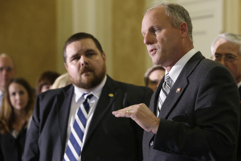 Sen. Jim Hendren, R-Gravette, right, answer reporters' questions about an alternative state Medicaid proposal as Rep. Bob Ballinger, R-Hindsville, left, and other legislators listen in the Old Supreme Court chamber at the Arkansas state Capitol in Little Rock, Ark., Wednesday, Feb. 19, 2014. (AP Photo/Danny Johnston)