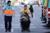 <p>An injured passenger is taken away in a wheelchair from a train station in Barcelona, Spain, Friday, July 28, 2017. (Photo: Adrian Quiroga/AP) </p>