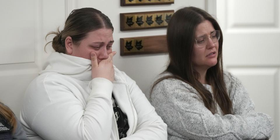 Two unidentified woman hold back tears at a news conference at city hall on the murder of eight people in the same family on January 5, 2023 in Enoch, Utah