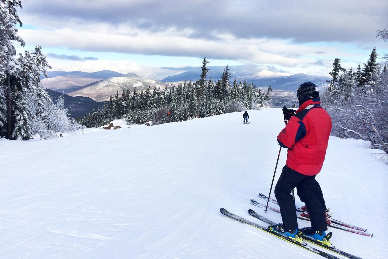 snowy slope in the mountains with two skiers in North Conway, New Hampshire