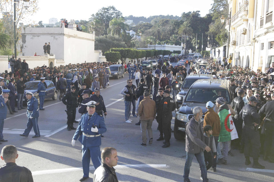People gather during the funeral of late Algerian military chief Gaid Saleh in Algiers, Algeria, Wednesday, Dec. 25, 2019. Algeria is holding an elaborate military funeral for the general who was the de facto ruler of the gas-rich country amid political turmoil throughout this year. (AP Photo/Fateh Guidoum)