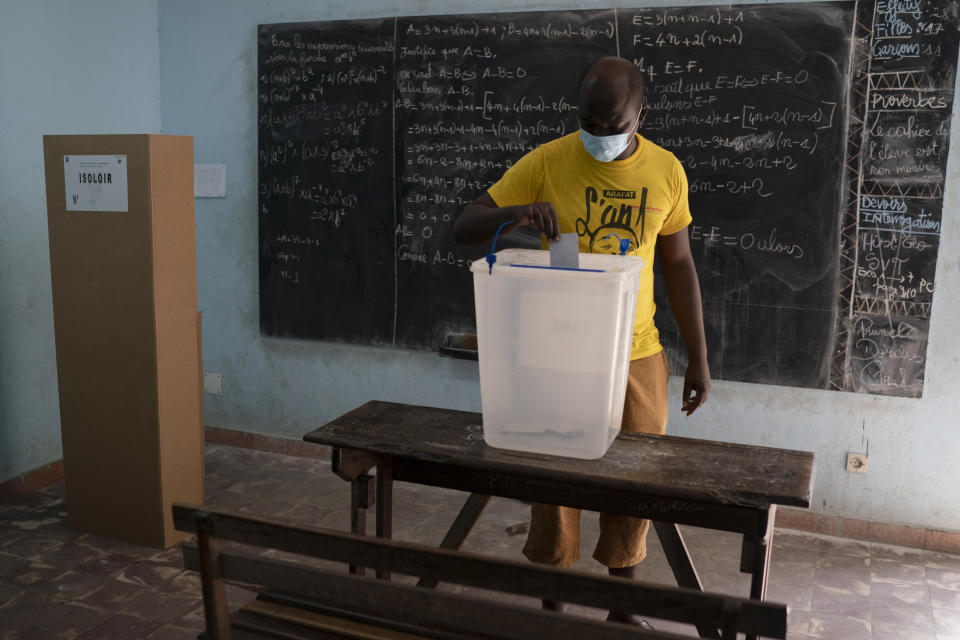 A man casts his vote during presidential election in Abidjan, Ivory Coast, Saturday, Oct. 31, 2020. Tens of thousands of security forces deployed across Ivory Coast on Saturday as the leading opposition parties boycotted the election, calling President Alassane Ouattara's bid for a third term illegal. (AP Photo/Leo Correa)