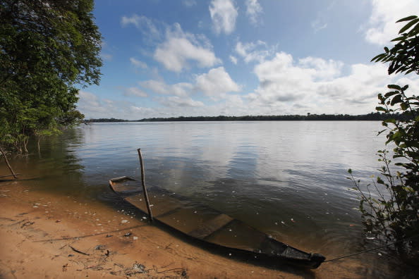 An old boat is submerged in the Xingu River near the site where the Belo Monte dam complex is under construction in the Amazon basin on June 14, 2012 near Altamira, Brazil. Belo Monte will be the world’s third-largest hydroelectric project and will displace up to 20,000 people while diverting the Xingu River and flooding as much as 230 square miles of rainforest.