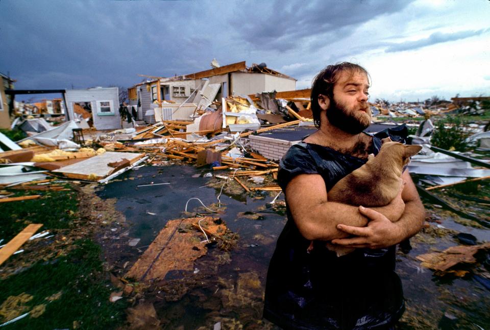 Gary Davis, with his Chihuahua Boo Boo, in front of his mobile home in the Goldcoaster Mobile Home Park in Florida City, the morning after Hurricane Andrew hit overnight in 1992.