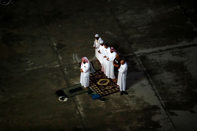 FILE PHOTO: Muslim pilgrims pray as they walk to cast their stones at a pillar symbolising the stoning of Satan during the annual haj pilgrimage in Mina