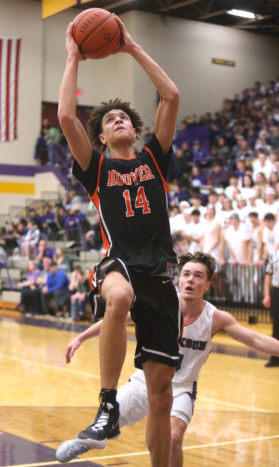 Elijah Barker, 14, right, of Hoover goes to the basket for a dunk after getting by JJ Vaughan, rear, of of Jackson during their game at Jackson on Friday, Jan. 14, 2022.