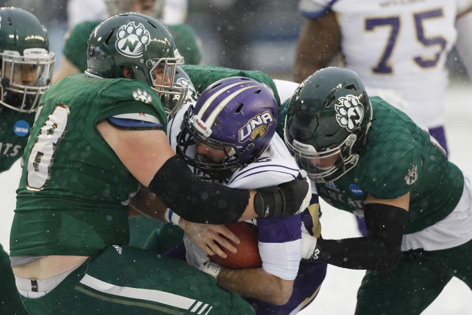 North Alabama quarterback Jacob Tucker, center, is sacked by Northwest Missouri State defensive tackle Caleb Mather, left, and linebacker Jacob Vollstedt during the first half of the NCAA Division II championship football game, Saturday, Dec. 17, 2016, in Kansas City, Kan. (AP Photo/Colin E. Braley)