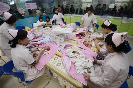 Infants undergo a daily medical examination at a maternal and child health care hospital in Taiyuan, Shanxi province in this December 3, 2012 file photo. REUTERS/Stringer/Files