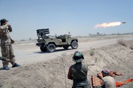 Iraq's Shi'ite paramilitaries launch a rocket towards Islamic State militants at North of Fallujah in province of Anbar, July 6, 2015. REUTERS/Stringer