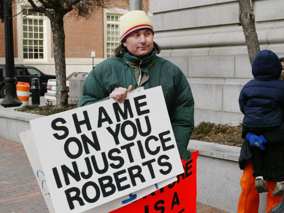 Chris Murphy, a member of an international Socialist organization, protests outside the Federal Courthouse in Providence, RI., Tuesday morning, Feb. 12, 2008 during a visit by U.S. Supreme Court Chief Justice John G. Roberts.