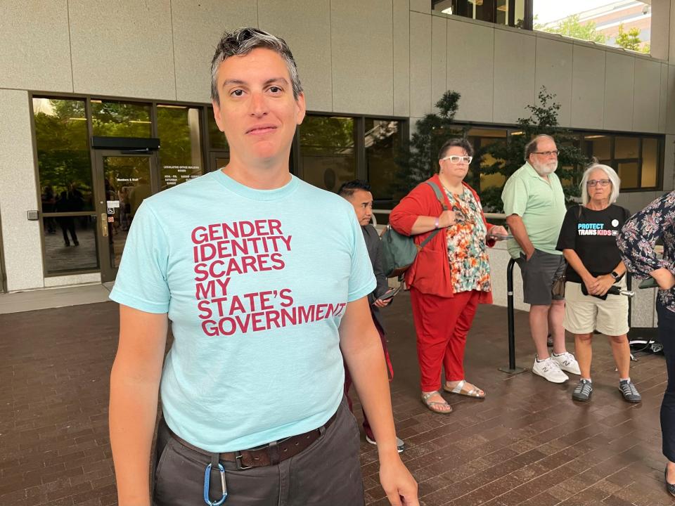 D Sellars, a nonbinary parent from Fuquay-Varina, N.C., stands outside the Legislative Office Building in Raleigh, N.C., Tuesday, June 20, 2023. Sellars was among dozens of LGBTQ+ people who showed up to speak in committee against a bill restricting gender-affirming care access but was not given time to testify.