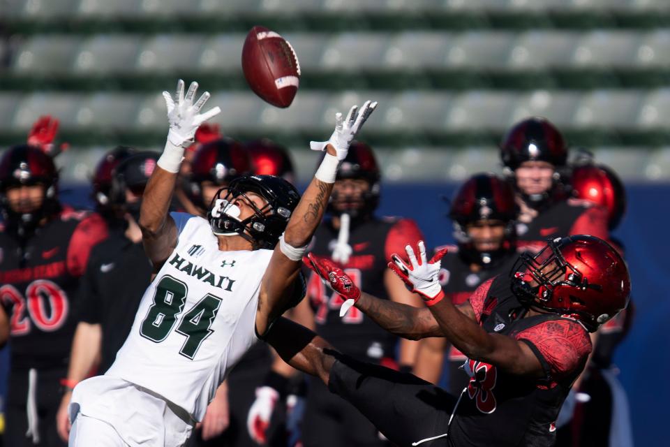 Hawaii wide receiver Nick Mardner, left, reaches to catch the ball in front of San Diego State cornerback Darren Hall during the first half of an NCAA college football game Saturday, Nov. 14, 2020, in Carson, Calif. Mardner did not make the catch. (AP Photo/Kyusung Gong)