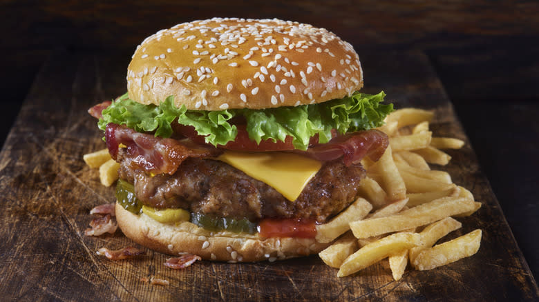 burger and fries on cutting board