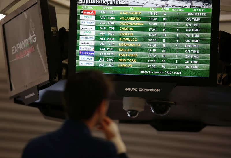 A screen displaying the departures shows the Avianca 431 flight cancelled after El Salvador's President Nayib Bukele accused Mexico of allowing a dozen confirmed coronavirus (COVID-19) cases to board the flight, in Mexico City