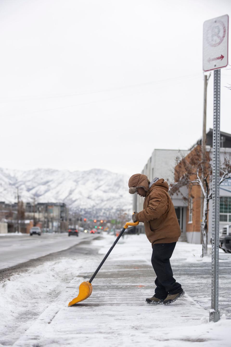 People are pictured shoveling snow after an overnight storm in Draper on Jan. 10, 2024. | Marielle Scott, Deseret News