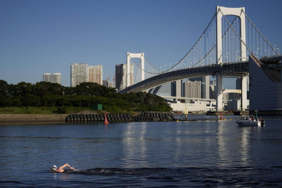 Backdropped by the Rainbow Bridge, Florian Wellbrock, of Germany, competes in the men's marathon swimming event at the 2020 Summer Olympics, Thursday, Aug. 5, 2021, in Tokyo, Japan. (AP Photo/Jae C. Hong)