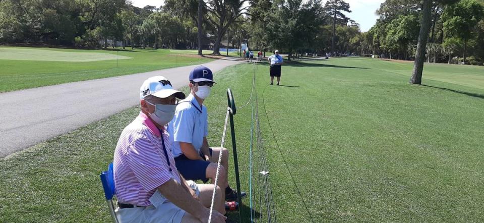 Rusty MacDonald, 39, right, and his father, also Rusty, watch practice play at the RBC Heritage Wednesday. “I can’t tell you how nice it is to watch and what a beautiful day,” the senior MacDonald said.